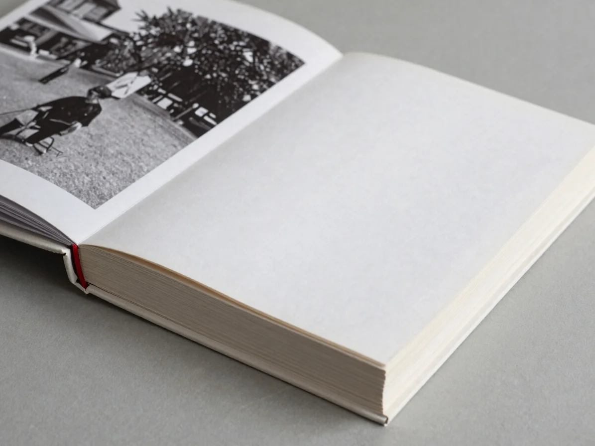Close detail of a bound paperback book beside a folded brochure,